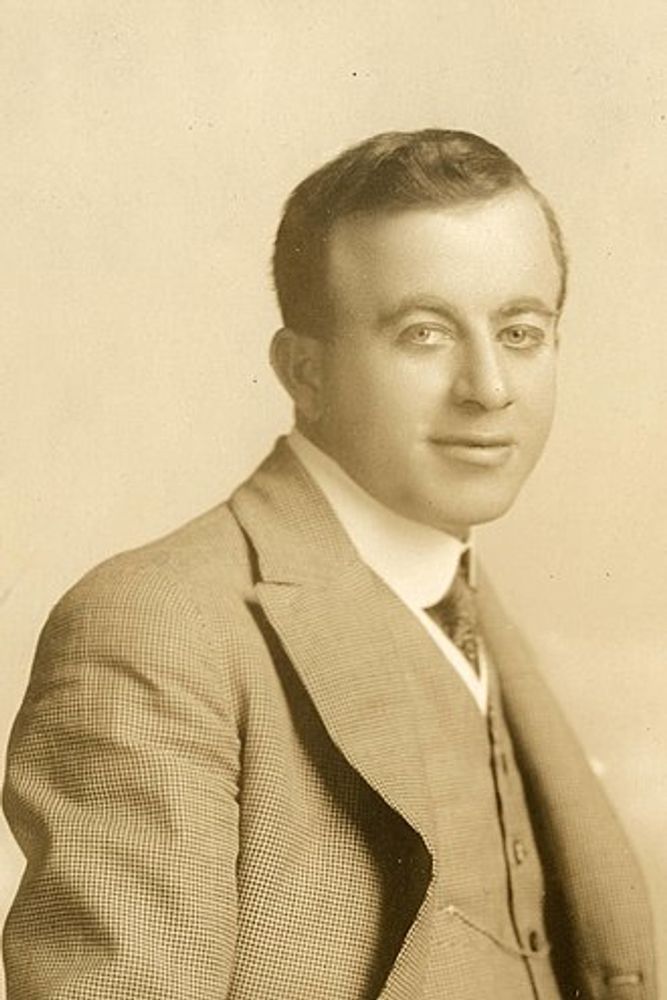Conklin in 1919. Black and white picture. He is wearing a suit, a tie and a vest. He is looking at the camera. 