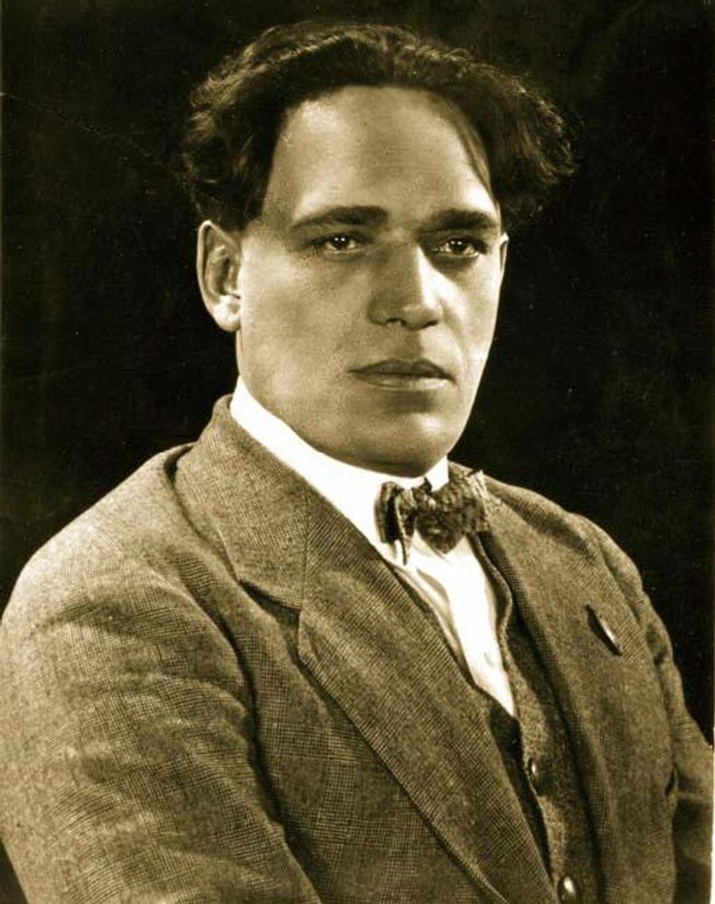 Amvrosy Buchma, undated picture. Black and white. He is wearing a suit, a vest, a white shirt and a bow tie. His hair is dark.