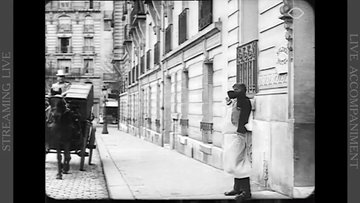 A man is on the sidewalk, close to a construction.